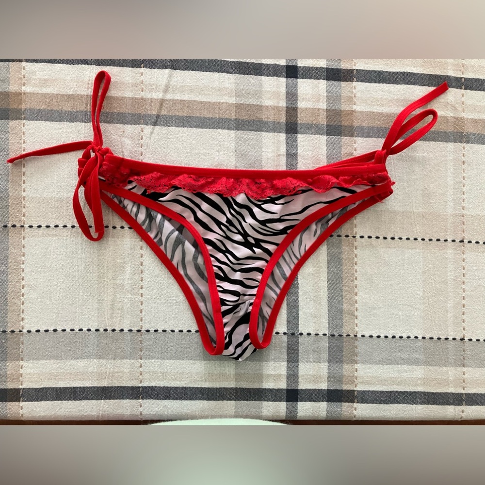 Women’s swim bottoms Brazilian style zebra print with red trim wore once